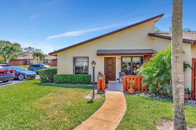 view of front of property with a front lawn and stucco siding