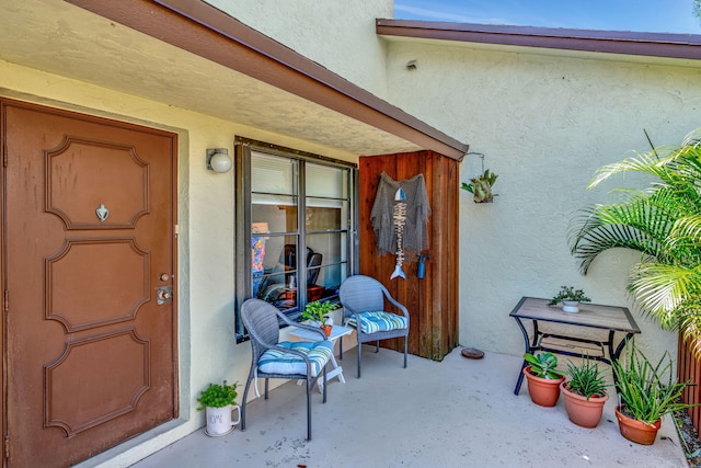 view of exterior entry featuring stucco siding