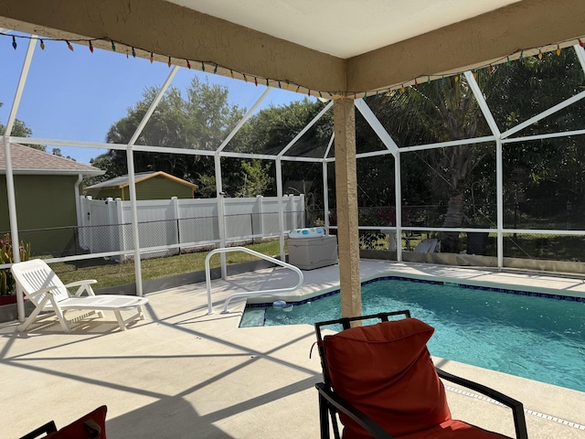 view of pool with a lanai, fence, a fenced in pool, and a patio