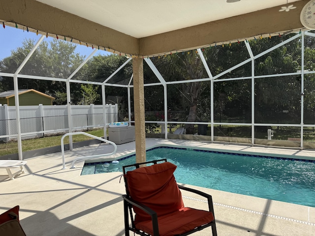 view of pool with glass enclosure, a patio area, fence, and a fenced in pool