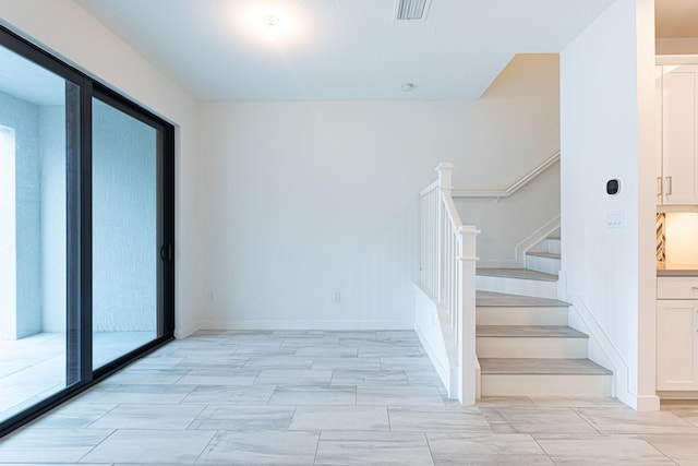 stairs featuring baseboards and visible vents