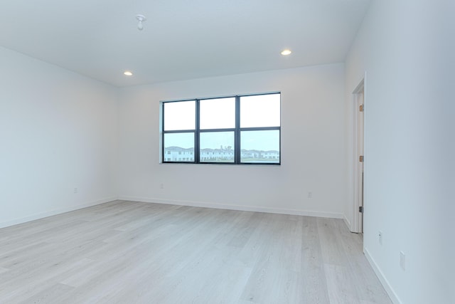 unfurnished room featuring recessed lighting, baseboards, and light wood finished floors