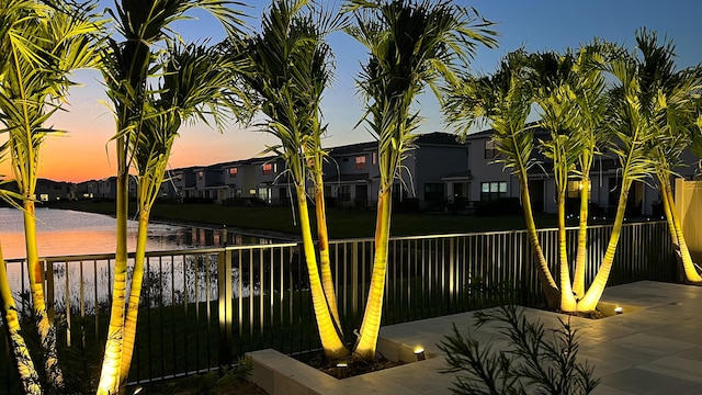 exterior space featuring a water view, a fenced backyard, and a residential view