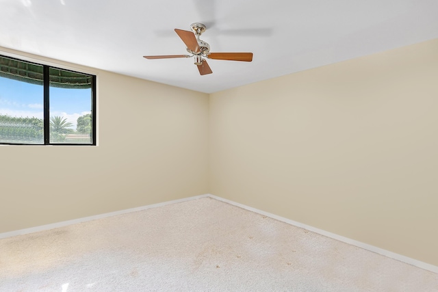 unfurnished room with carpet flooring, baseboards, and ceiling fan