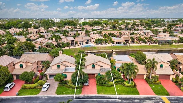 drone / aerial view with a residential view and a water view
