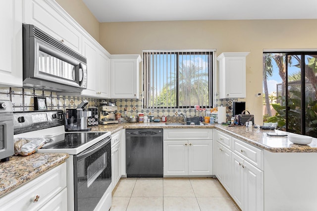 kitchen featuring dishwashing machine, light tile patterned floors, a sink, electric range oven, and black microwave