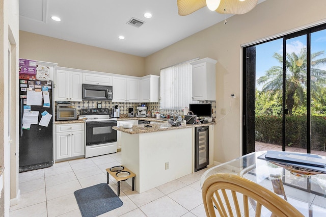 kitchen with tasteful backsplash, black appliances, beverage cooler, and white cabinets