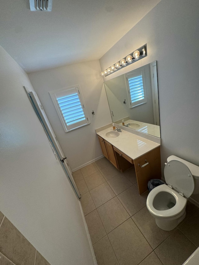 bathroom featuring tile patterned flooring, visible vents, toilet, and vanity