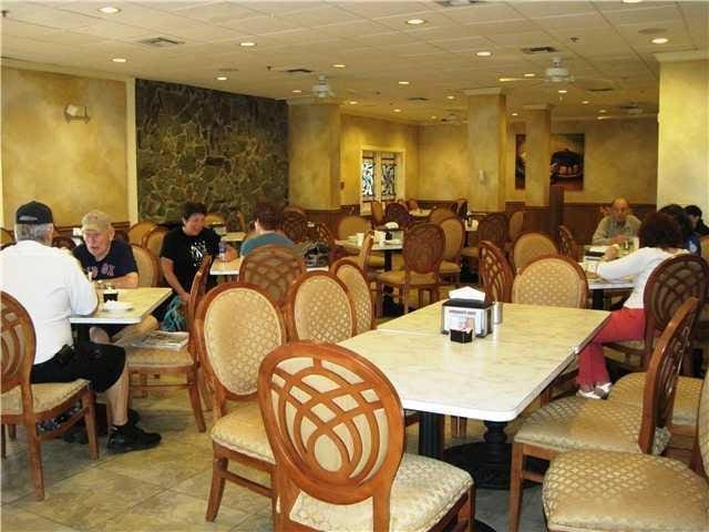 dining space featuring light tile patterned floors, a drop ceiling, and recessed lighting