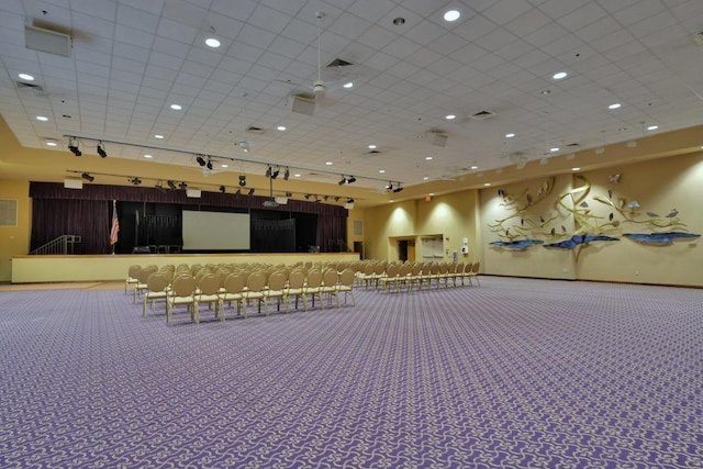 miscellaneous room with carpet floors, rail lighting, visible vents, and a drop ceiling