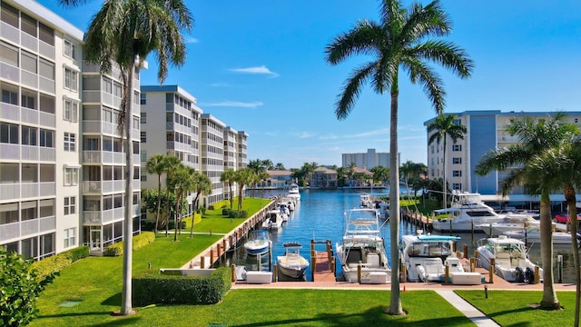 dock area with a lawn and a water view