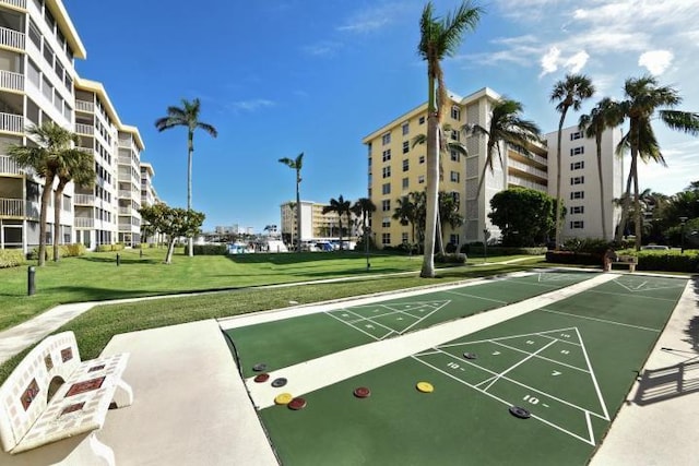 surrounding community featuring shuffleboard and a lawn