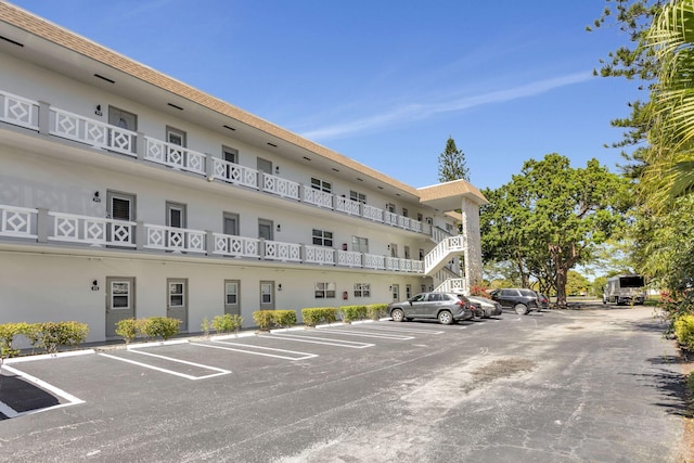 view of building exterior with uncovered parking