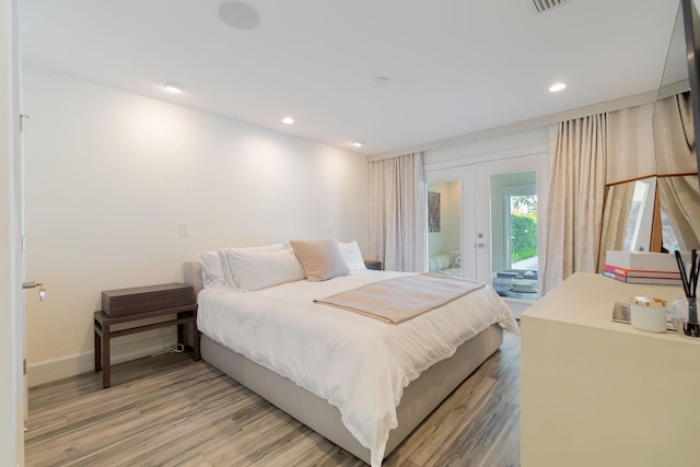 bedroom featuring baseboards, light wood finished floors, recessed lighting, access to exterior, and french doors