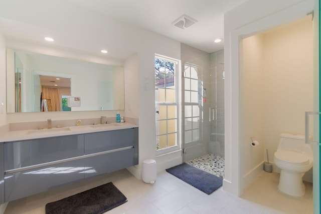 bathroom with a sink, toilet, and a shower stall