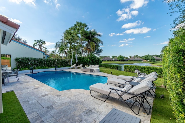 view of swimming pool featuring outdoor lounge area, a patio, and a fenced in pool