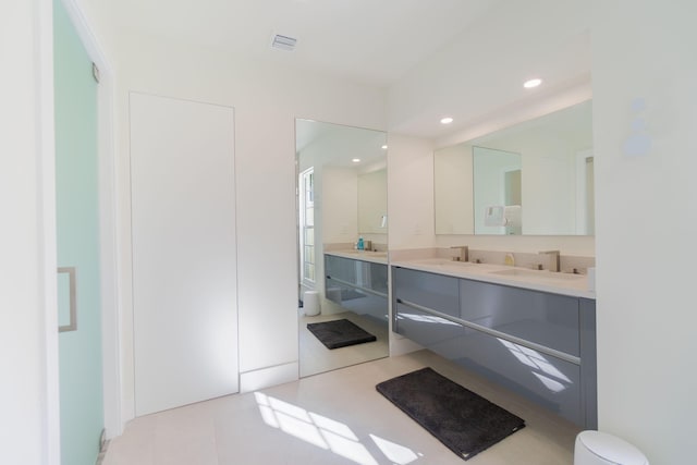 full bath with double vanity, recessed lighting, visible vents, and a sink