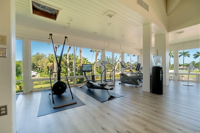 gym with visible vents, wood finished floors, and wooden ceiling