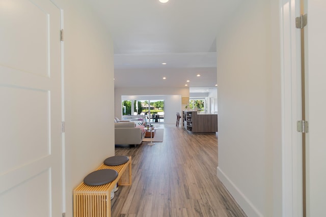 hall with recessed lighting, baseboards, and wood finished floors