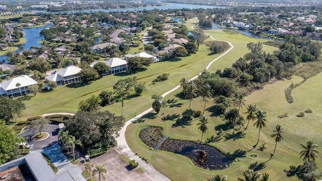 bird's eye view with a residential view, a water view, and golf course view