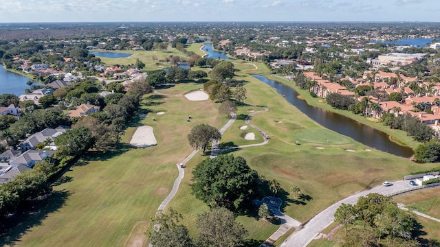 aerial view with view of golf course, a water view, and a residential view