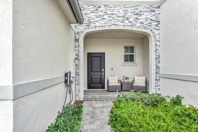 entrance to property with stucco siding