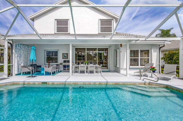 back of property with outdoor lounge area, a patio, an outdoor pool, and stucco siding