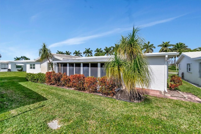 exterior space featuring a yard and stucco siding