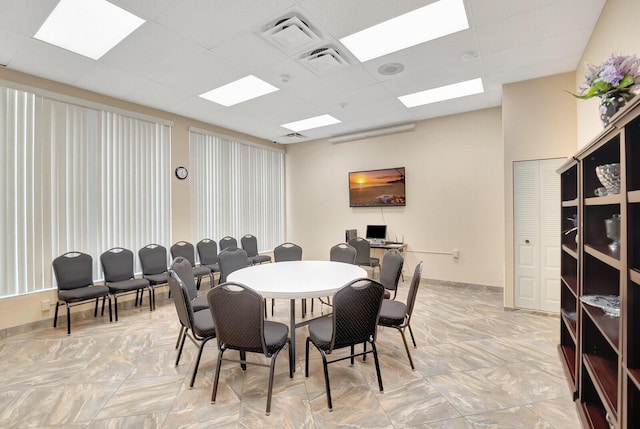 dining area featuring a paneled ceiling and visible vents