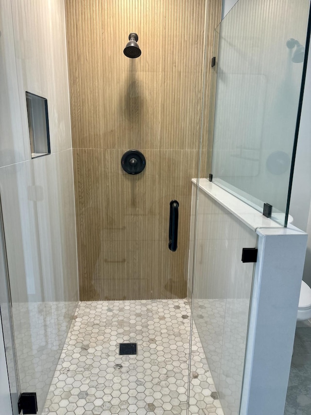 full bathroom featuring tile patterned flooring, a stall shower, and toilet