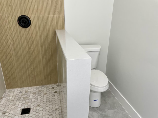 full bath with tile patterned floors, toilet, baseboards, and walk in shower