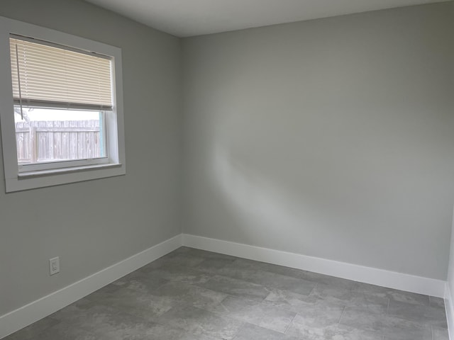 empty room featuring baseboards