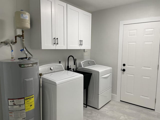 washroom with cabinet space, electric water heater, and separate washer and dryer