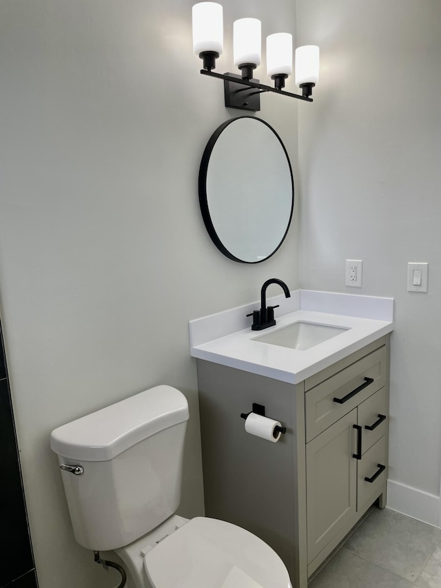 bathroom featuring baseboards, a chandelier, toilet, tile patterned floors, and vanity