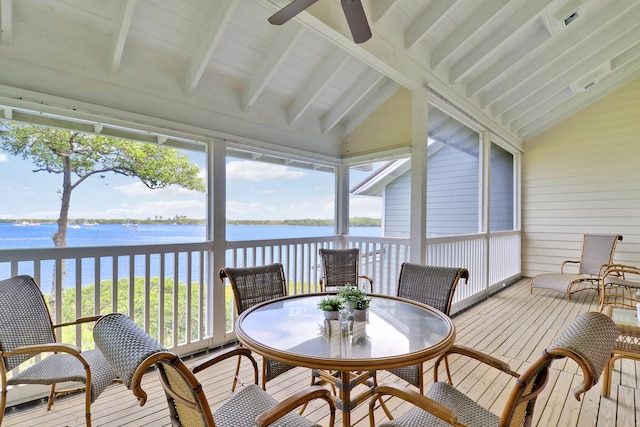 sunroom / solarium featuring plenty of natural light, a water view, vaulted ceiling with beams, and ceiling fan