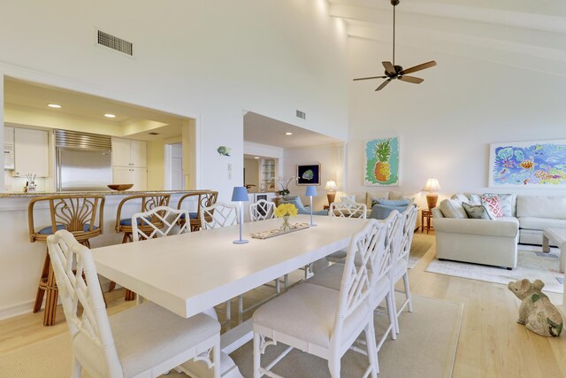 dining area featuring recessed lighting, visible vents, beamed ceiling, and light wood-style flooring