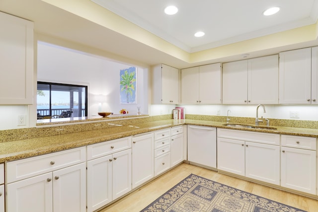 kitchen featuring white cabinetry, dishwasher, and a sink