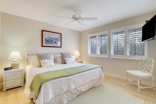 bedroom featuring wood finished floors, a ceiling fan, and baseboards