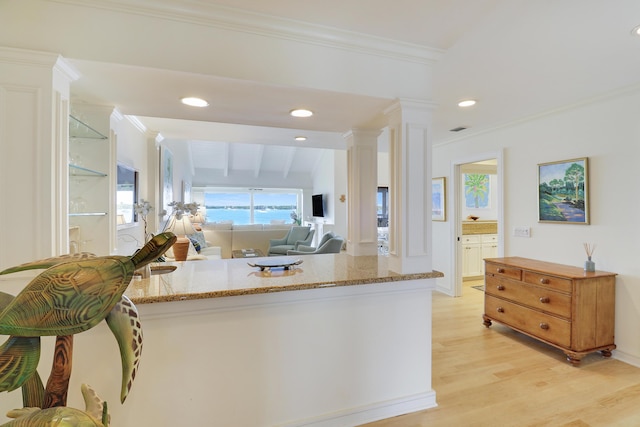 kitchen featuring crown molding, decorative columns, recessed lighting, light stone countertops, and light wood-type flooring