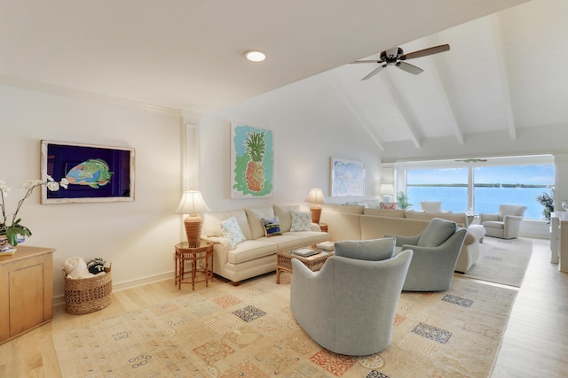 living area with vaulted ceiling with beams, a water view, a ceiling fan, baseboards, and light wood-style floors