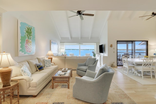 living area featuring light wood-style floors, beam ceiling, high vaulted ceiling, and a ceiling fan