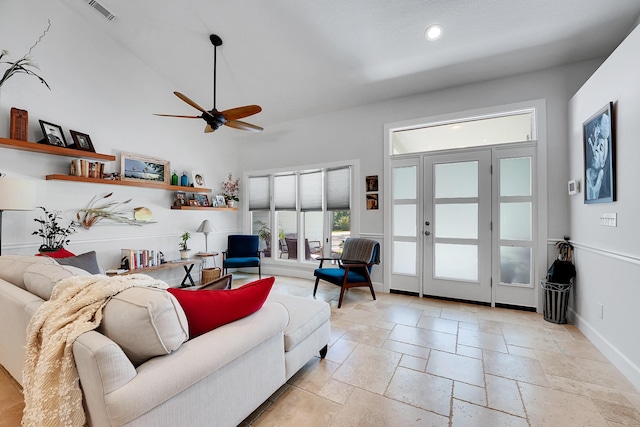 living area featuring recessed lighting, stone tile flooring, visible vents, ceiling fan, and baseboards