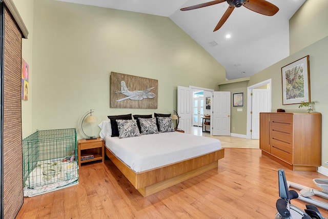 bedroom with high vaulted ceiling, visible vents, baseboards, a ceiling fan, and light wood-type flooring