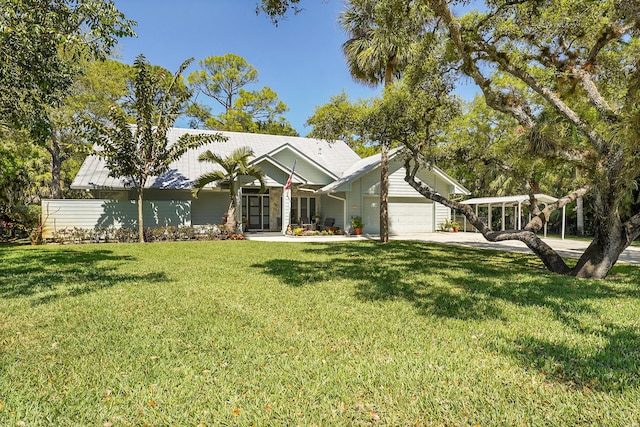 single story home featuring a front yard, driveway, and an attached garage