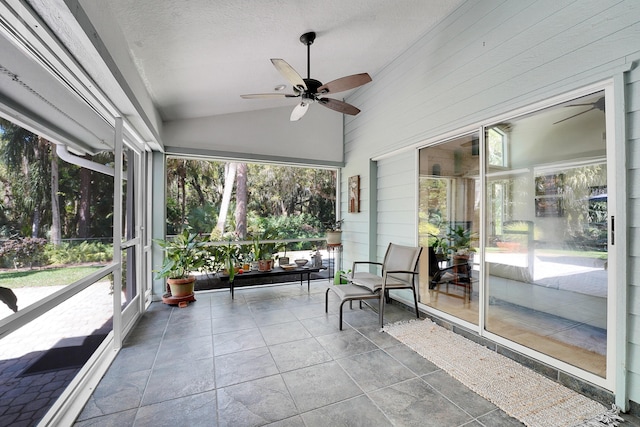 unfurnished sunroom with ceiling fan and vaulted ceiling