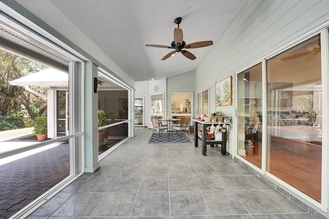 sunroom / solarium featuring ceiling fan