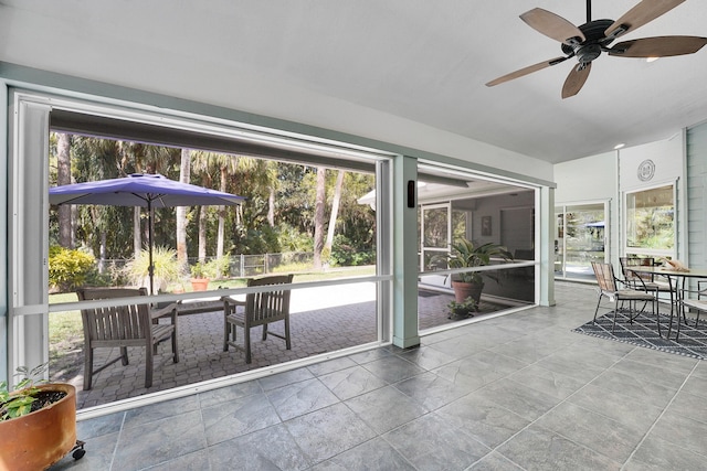 sunroom featuring plenty of natural light and a ceiling fan