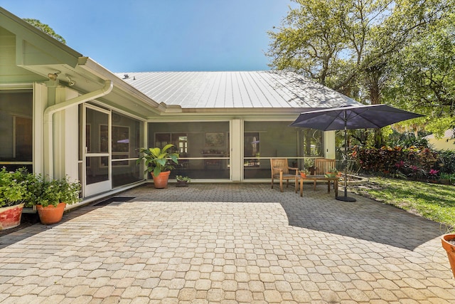 view of patio featuring a sunroom