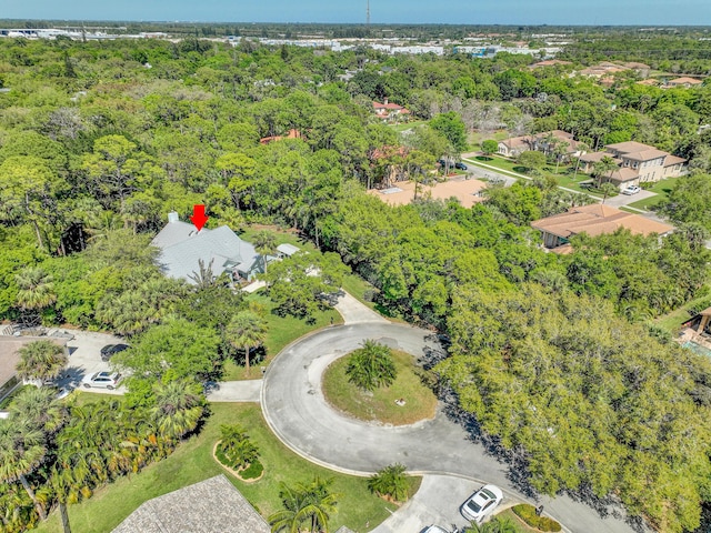 birds eye view of property featuring a wooded view