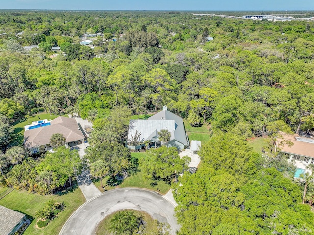 bird's eye view with a wooded view